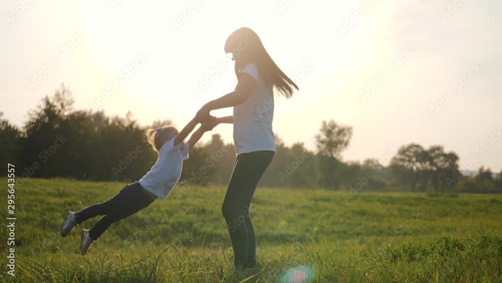 A happy little girl runs into the arms of her loving mother. The happiness of motherhood, friendship, trust, love. A happy little girl runs into the arms of her loving mother. The happiness of motherhood, friendship, trust, love.
