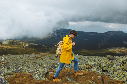 young awesome tourist walking on the valley. copy space always in seach of adventure. full length side view photo