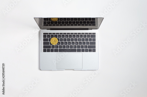 Laptop computer with Bitcoin cryptocurrency on work desk