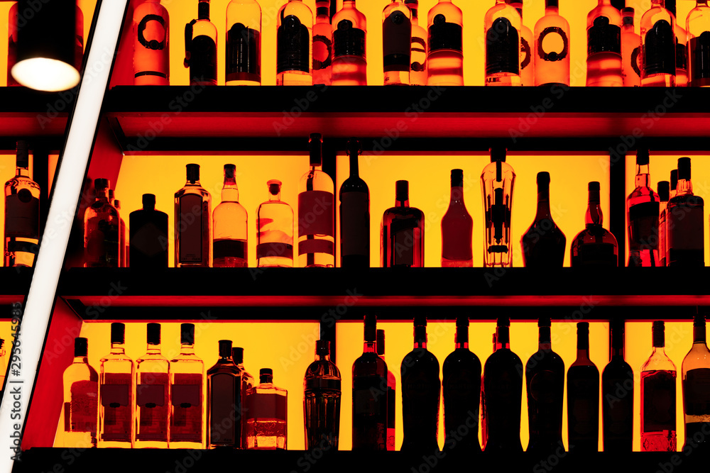 Bottles sitting on shelf in a bar Bottles sitting on shelf in a bar