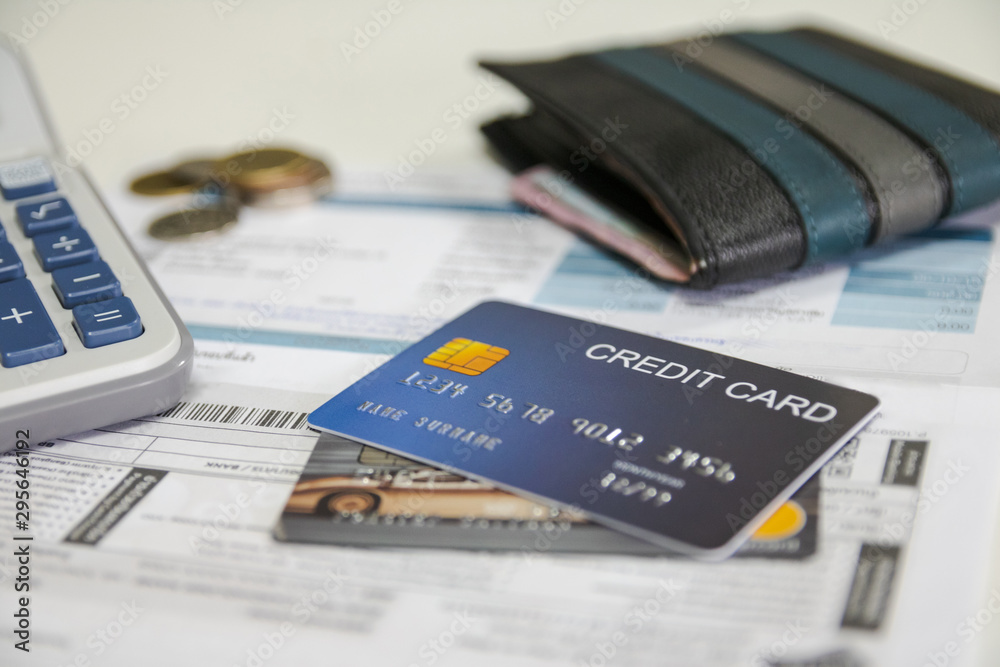 Credit cards, Baht coins, calculators, and invoice bills Put on the white table Credit cards, Baht coins, calculators, and invoice bills Put on the white table