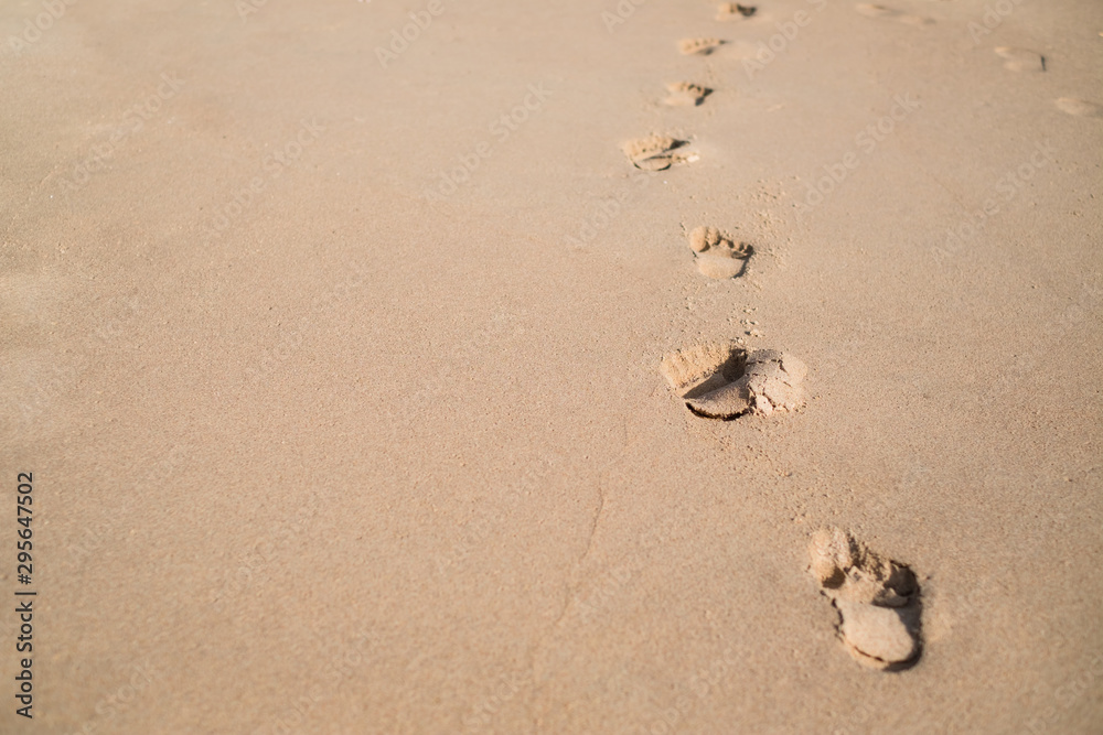 Footsteps on the sand beach background Footsteps on the sand beach background