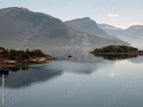 landscape with smoky mountains in the background and blue water in the foreground, beautiful blurry glare