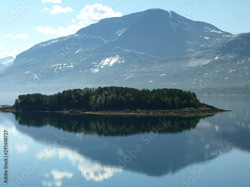 landscape with smoky mountains in the background and blue water in the foreground, beautiful blurry glare