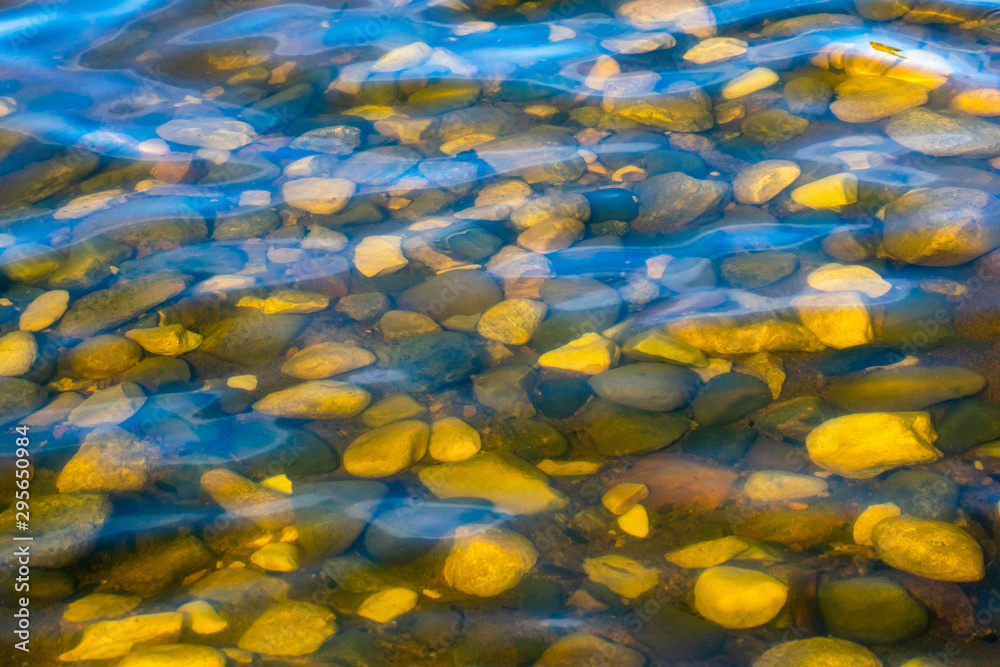 Insanely beautiful view of the rounded cobblestones in the clear water. Insanely beautiful view of the rounded cobblestones in the clear water.