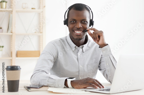 Customer service. Portrait of young african male technical support in call centre