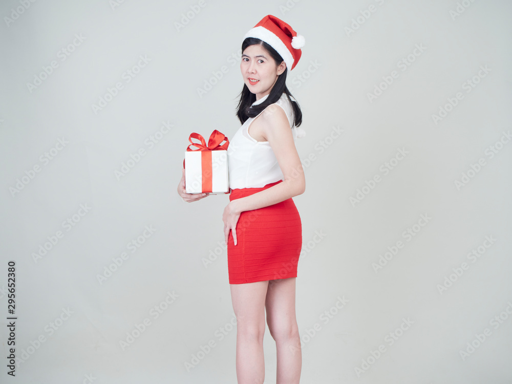 Beautiful woman in santa hat holding gift box Beautiful woman in santa hat holding gift box