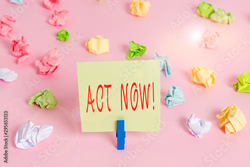 Writing note showing Act Now. Business concept for do not hesitate and start working or doing stuff right away Colored crumpled papers empty reminder pink floor background clothespin