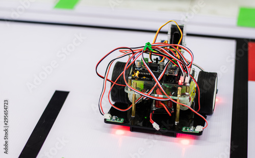 High school student is training to assemble robots for learning.