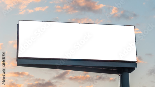 Mock up image: wide blank white billboard or large display and clouds against sunset warm sky. Consumerism, mockup, advertising, isolated white screen, background, template, copyspace concept