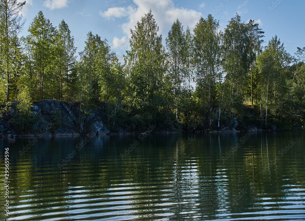 Water landscape of a mountain park.The picturesque landscape of the mountain natural park Ruskeala. Visible are rocks, a lake, coniferous forest, mountains, wildlife. Russia, Karelia.