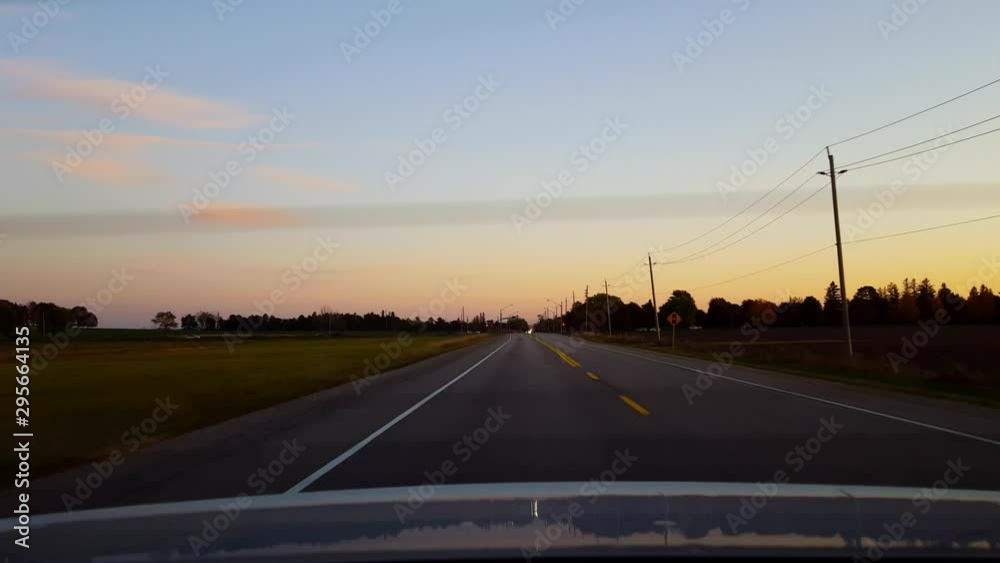 Rear View From Back of Car Driving Rural Countryside Road During Day. Car Point of View POV Behind Vehicle Country Street. Rear View From Back of Car Driving Rural Countryside Road During Day. Car Point of View POV Behind Vehicle Country Street.