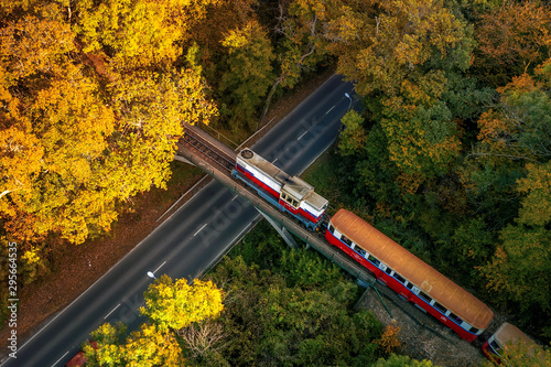 Forest train in amazing autumn colors. Bright lights, fantastic mood. Children's train in Budapest. Szechenyi hegy hill to huvosvolgy hill to huvosvolgy. Children's train operate by children. photo