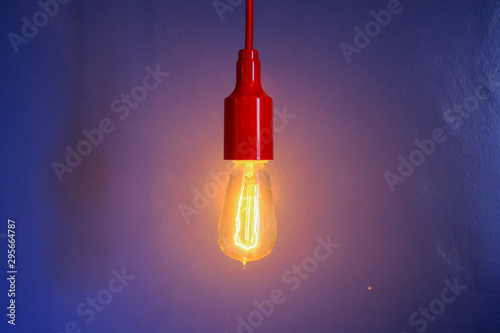 light bulb on blue background with copy space for text © GroovyGloryPhoto
