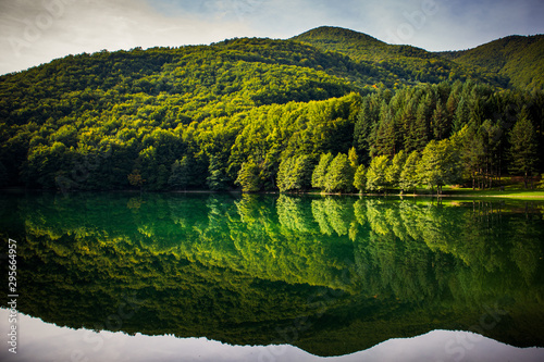 Beautiful turquoise lake surrounded by green forest and mountains. Balkana lake in Bosnia and Herzegovina.