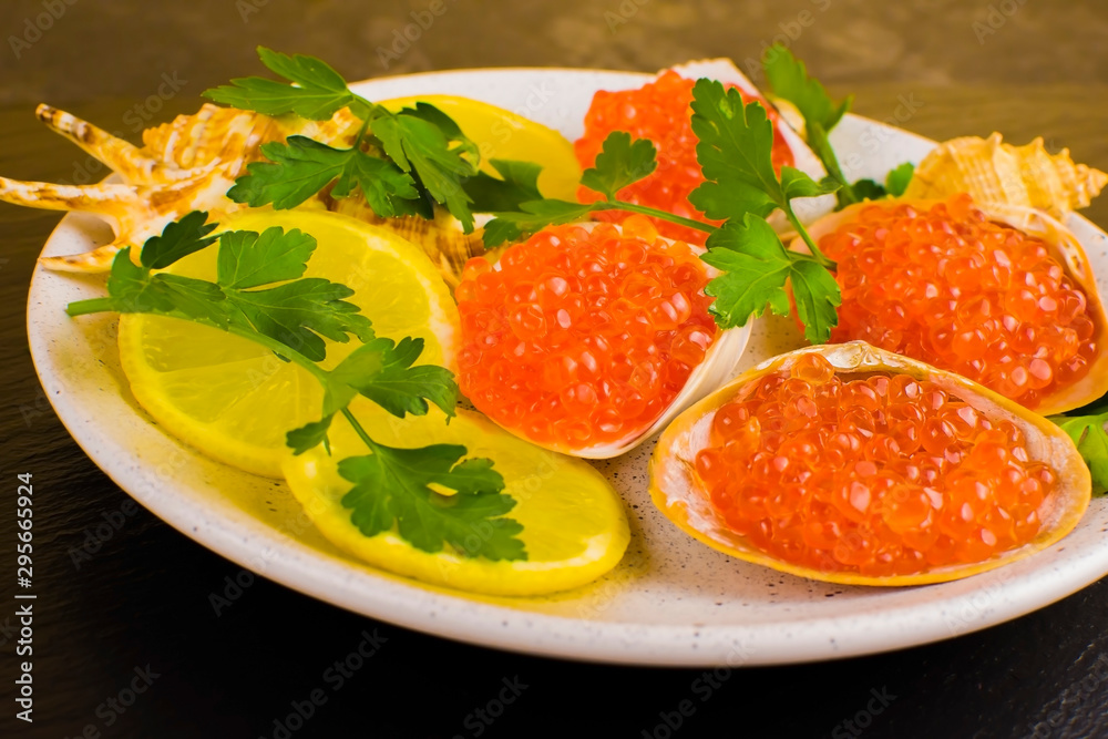 red caviar and seafood with lemon and herbs, seafood dish, delicacy. close-up, selective focus red caviar and seafood with lemon and herbs, seafood dish, delicacy. close-up, selective focus