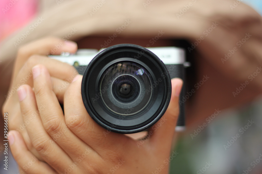 focus of women photographer hold camera and taking a photo. woman is a professional photographer with camera focus of women photographer hold camera and taking a photo. woman is a professional photographer with camera