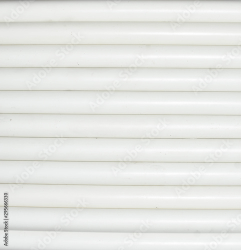 White electrical conduit arranged in a pattern.The white electrical cables are arranged into patterns.