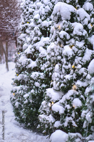 Beautiful Christmas background with garlands and bokeh. New Year colorful picture. Photo of a winter city street for design