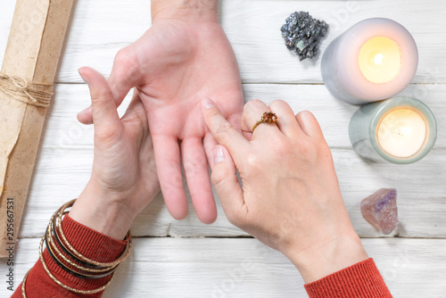 Fortune teller reading future by the hand. Palmistry. photo