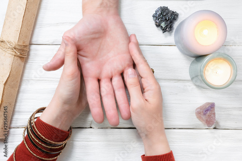 Fortune teller reading future by the hand. Palmistry.