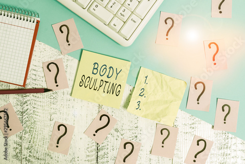 Text sign showing Body Sculpting. Business photo text activity of increasing the body s is visible muscle tone Writing tools, computer stuff and math book sheet on top of wooden table