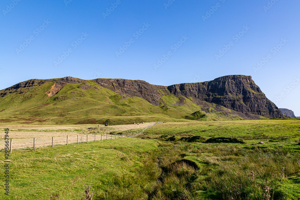 The headland near Neist Point on the Isle of Skye, with a blue sky overhead