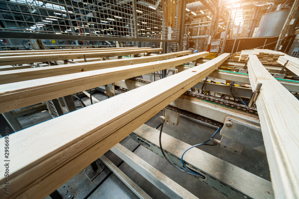 Fototapeta premium Production line of the wooden floor factory. CNC automatic woodworking machine.