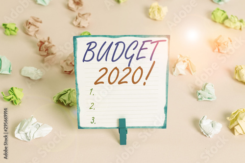 Handwriting text Budget 2020. Conceptual photo estimate of income and expenditure for next or current year Colored crumpled papers empty reminder pink floor background clothespin © Artur