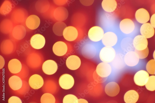 Many soft orange, red and yellow blurry bokeh light on dark red background in Christmas and New Year festival day, can use for background