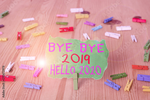 Word writing text Bye Bye 2019 Hello 2020. Business photo showcasing saying goodbye to last year and welcoming another good one Colored clothespin papers empty reminder wooden floor background office