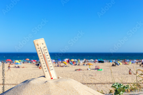 Thermometer for the temperature on the beach, in the summer in the heat. Global warming.