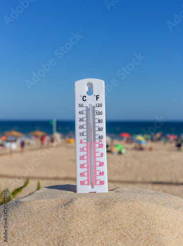 Thermometer for the temperature on the beach, in the summer in the heat. Global warming.