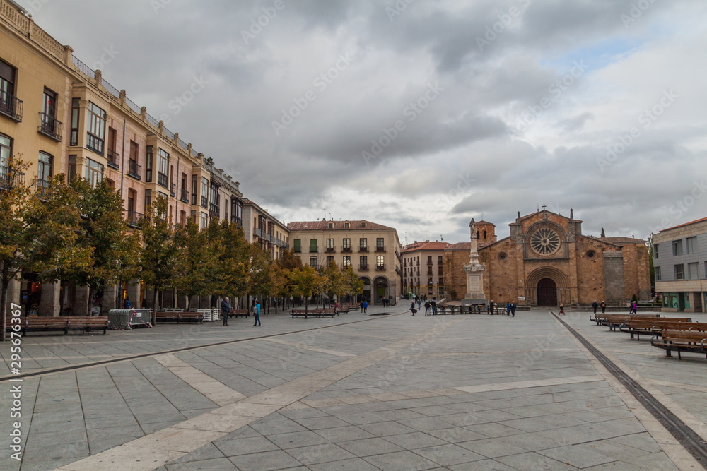 AVILA, SPAIN - OCTOBER 19, 2017: Santa Teresa de Jesus square and San Pedro Apostol church in Avila.