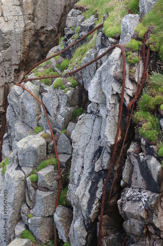 Rusty Steel Ropes on Cliff Face