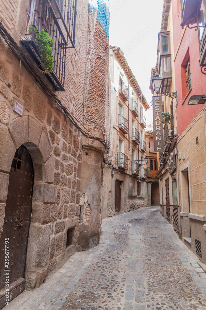 TOLEDO, SPAIN - OCTOBER 23, 2017: Narrow street in the old town of Toledo, Spain