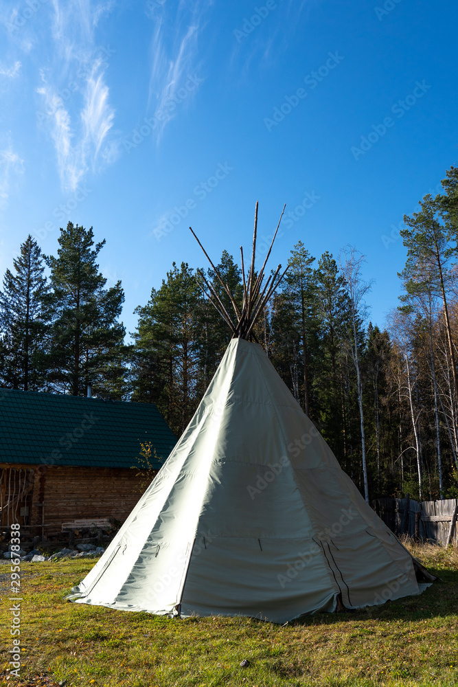 Native American wigwam in the forest. Modern material for the manufacture of wigwam. Yurt is the home of the northern peoples.