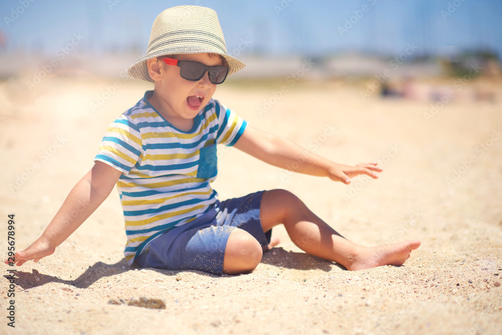 holiday, little boy three years old fun digging in the sand at the beach holiday, little boy three years old fun digging in the sand at the beach