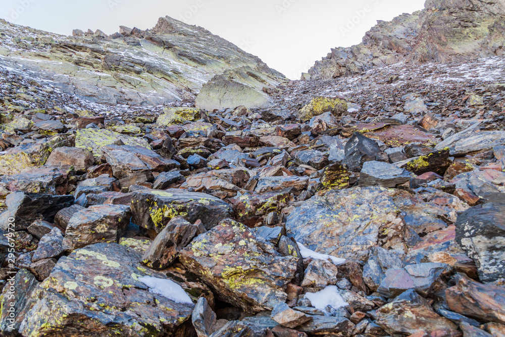 Obraz premium Rocks and snow at the slopes of Coma Pedrosa, highest mountain in Andorra