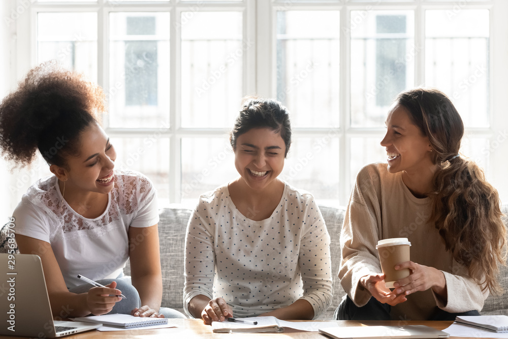Happy diverse girls having fun, studying together at home Happy diverse girls having fun, studying together at home