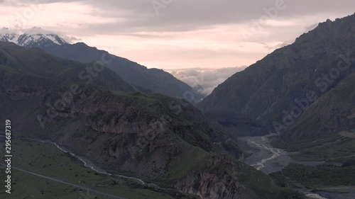 Sunset in Mountains in Georgia Kazbegi and Gergeti Trinity Church north Caucasus drone flight photo