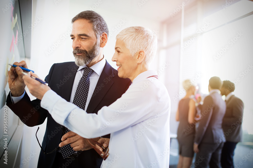 Portrait of happy business people discussing together in office Portrait of happy business people discussing together in office