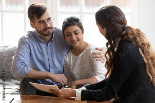 Realtor or financial advisor consulting diverse couple about deal
