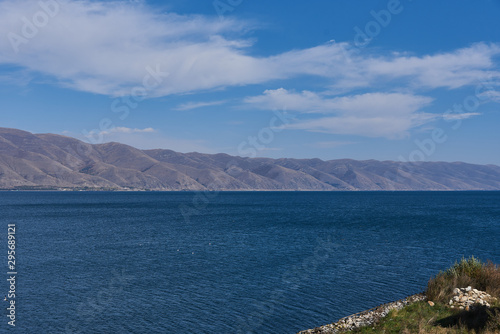 Dark blue lake Sevan on the background of mountains on the sky