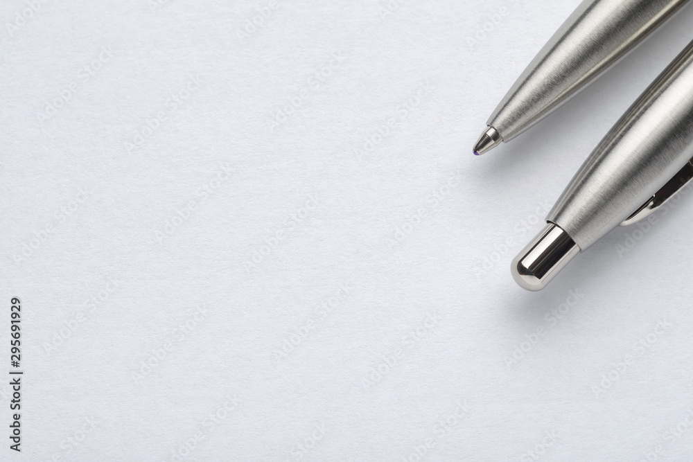 Metal ballpoint pen on white paper background Metal ballpoint pen on white paper background