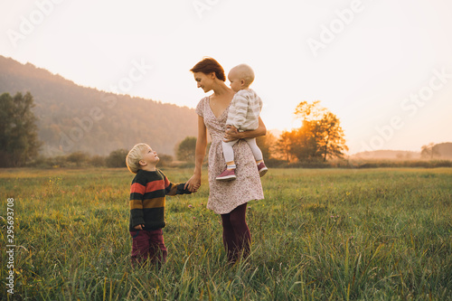 Family on nature. Mother with children outdoors.