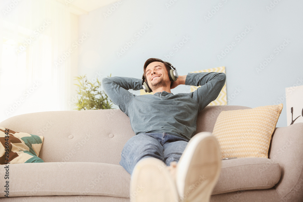 Handsome man listening to music at home