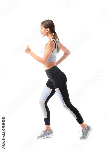 Sporty young woman running against white background