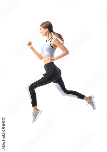Sporty young woman running against white background