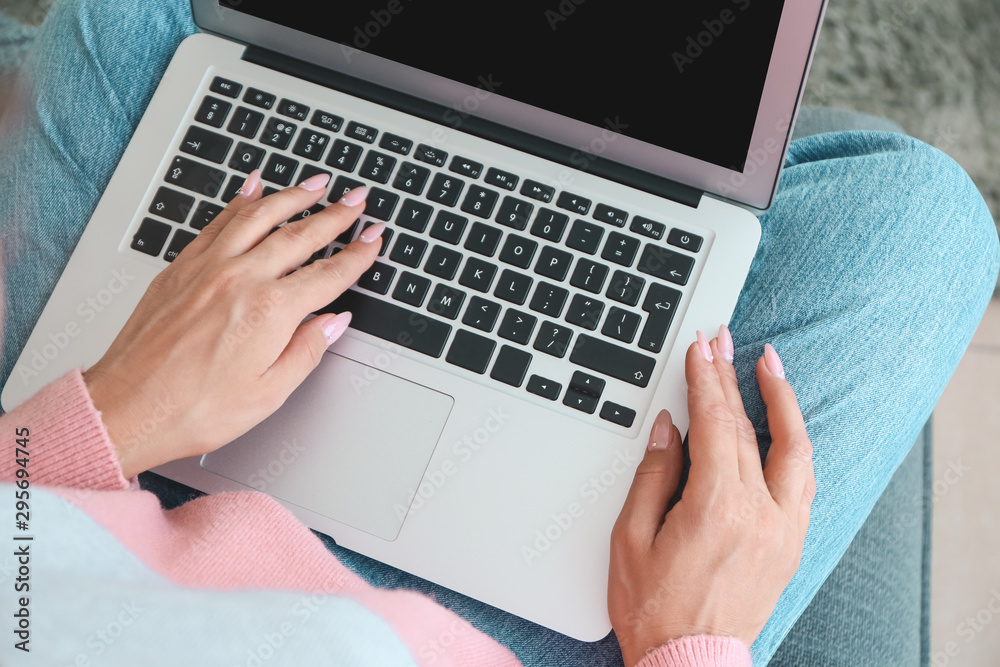 Young woman working on laptop at home, closeup Young woman working on laptop at home, closeup